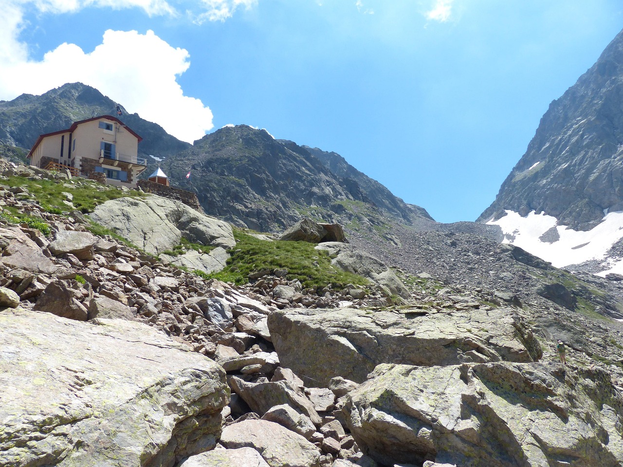 Rifugio panoramico tra le Alpi italiane, circondato da maestose montagne e natura incontaminata.